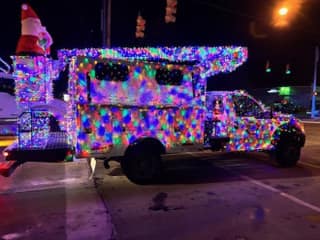A truck covered in holiday lights in the Christmas Parade
