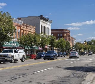 Historic storefronts along a sunny downtown Tecumseh street
