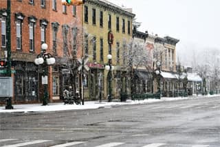 Snow-dusted historic storefronts on a downtown Tecumseh street